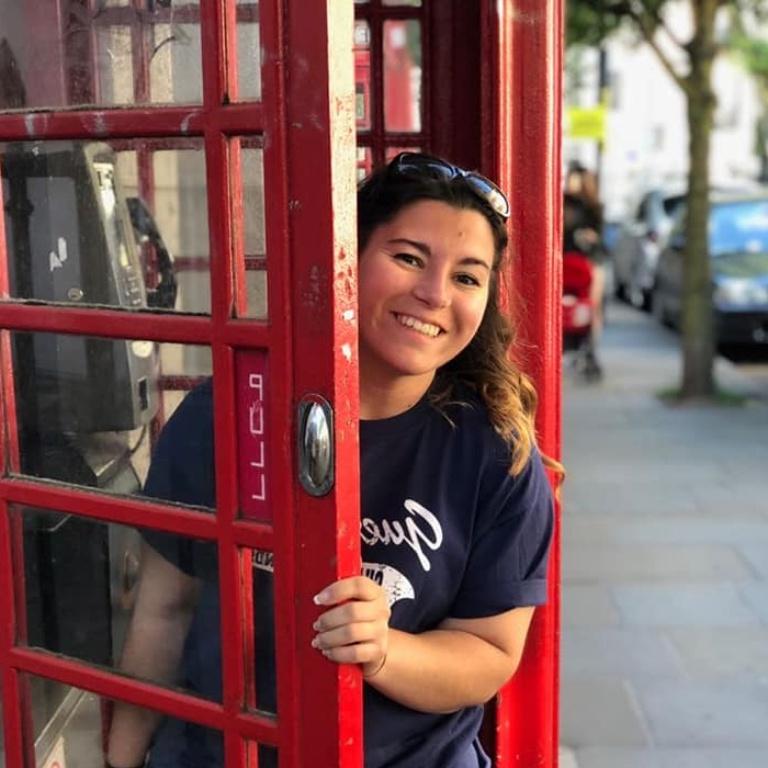 A student in a red phone booth.